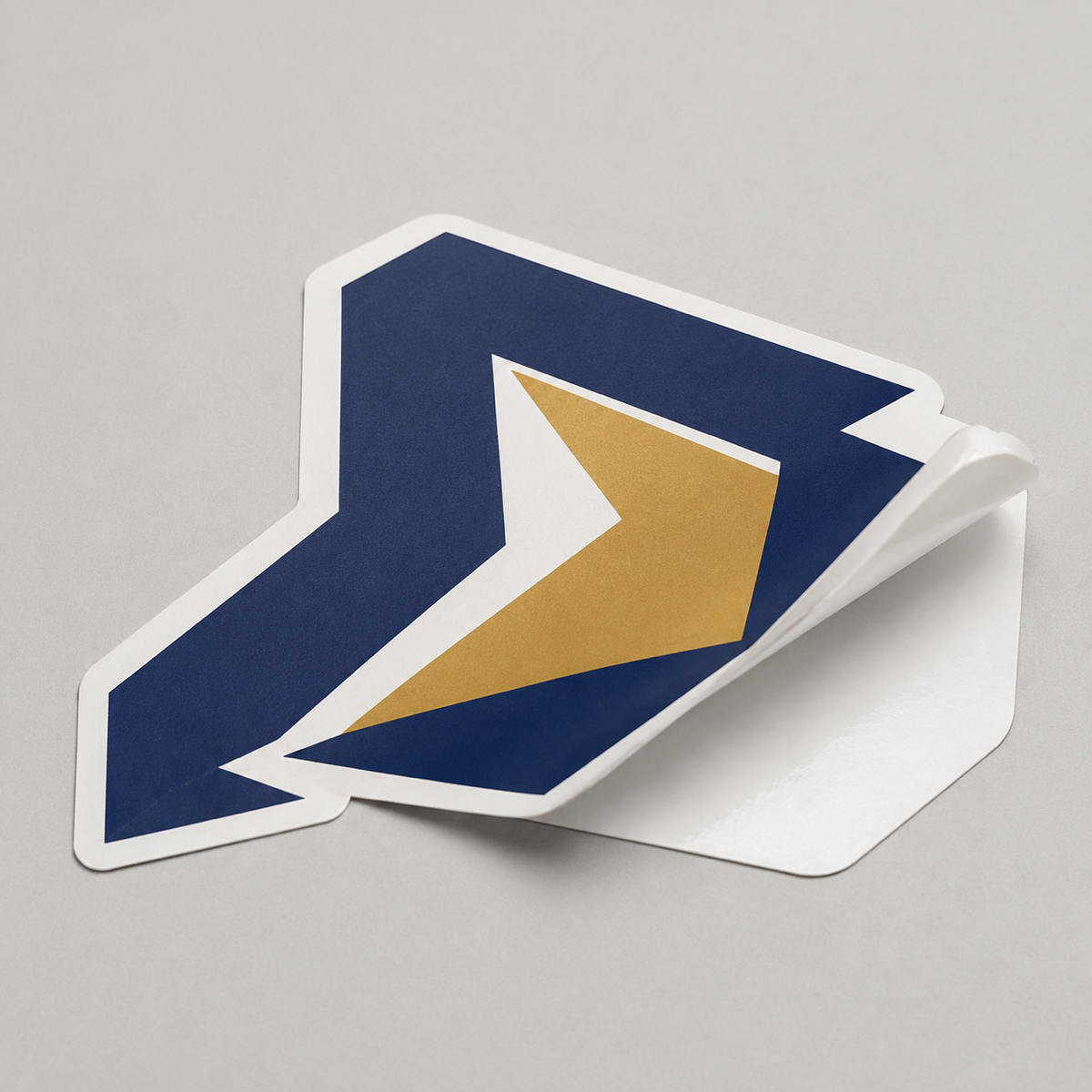 Contour die-cut vinyl sticker label half-lifted from its white backing
